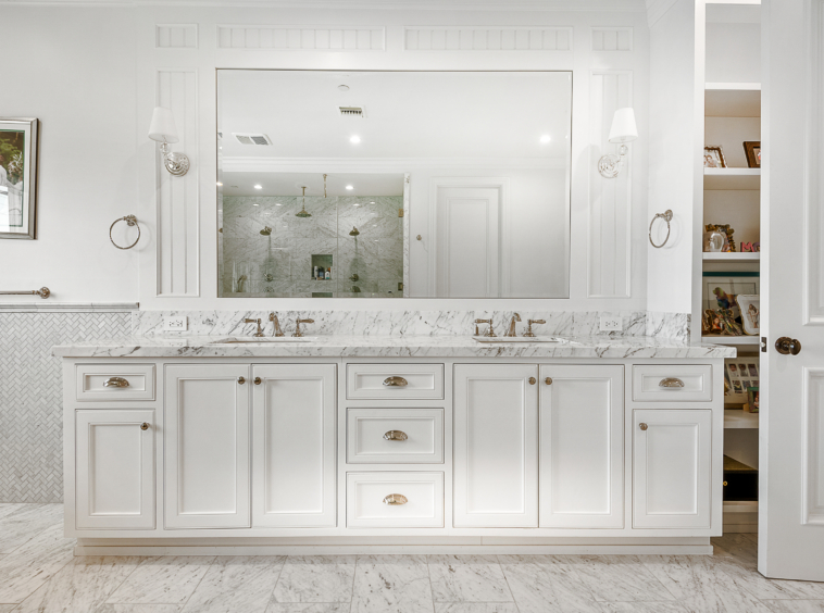 Large bathroom double vanity with marble flooring