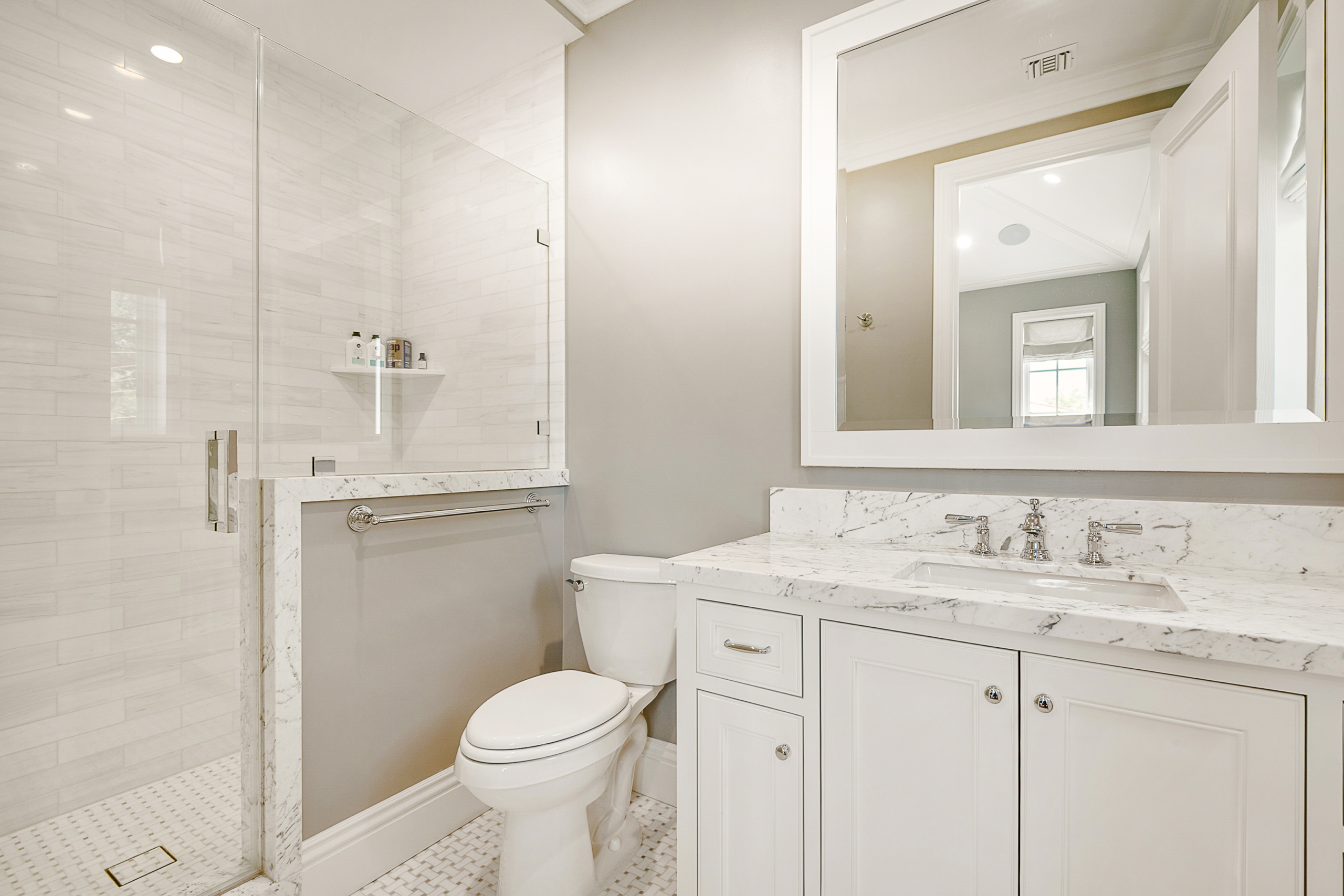 Grey and white bathroom with marble large walk-in shower