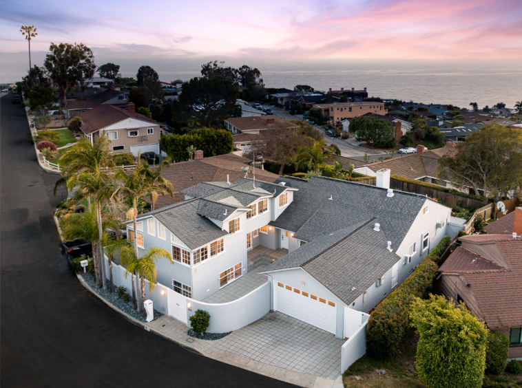 Aerial view of home and surrounding properties with ocean view