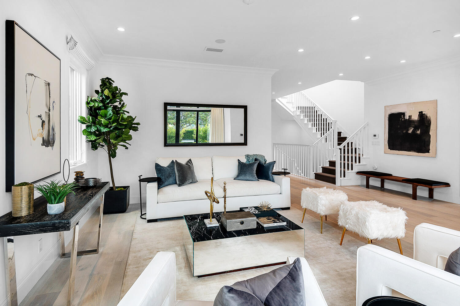 Modern bright white living area with view of staircase
