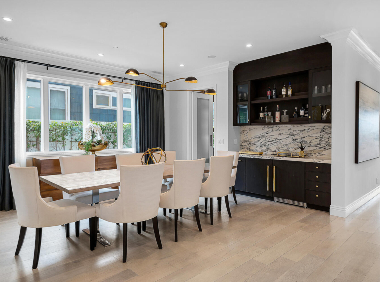 Modern dining area and chandelier. Large wet bar and built-in seating area