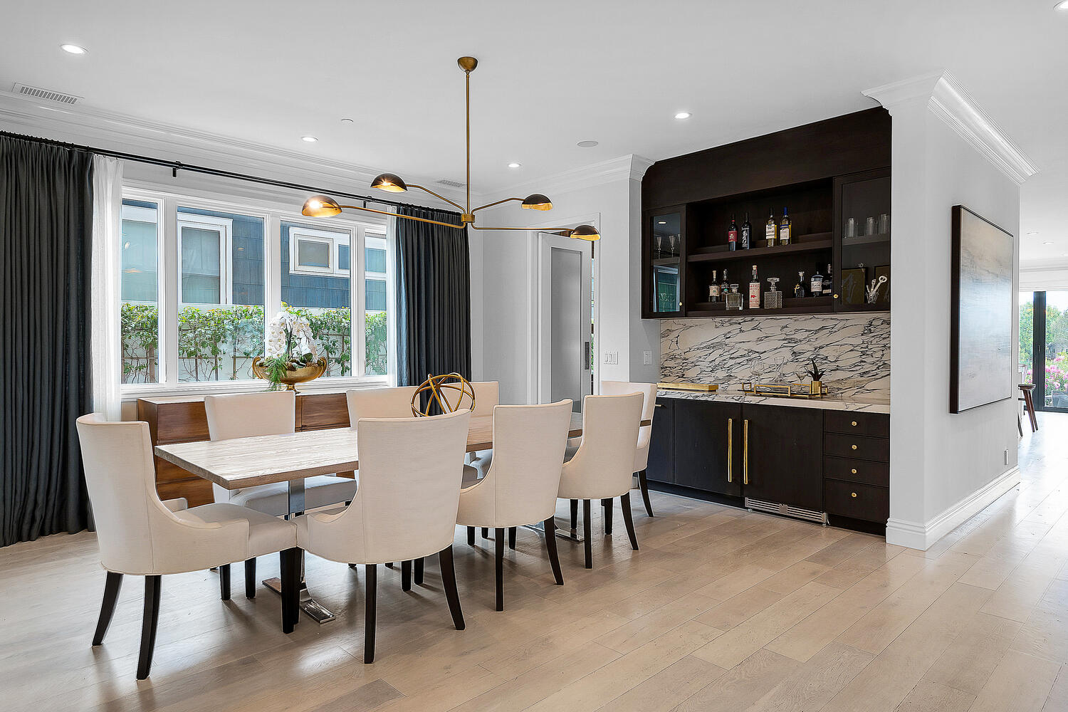 Modern dining area and chandelier. Large wet bar and built-in seating area