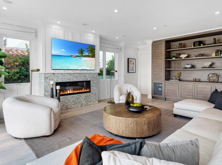 Modern living room with in-wall fireplace and custom built-in shelving and storage