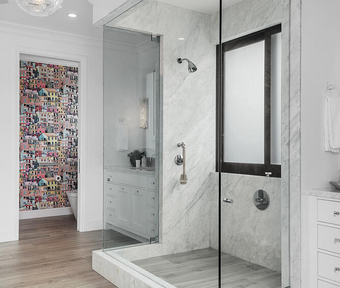 bright bathroom with large walk-in glass shower and light flooring