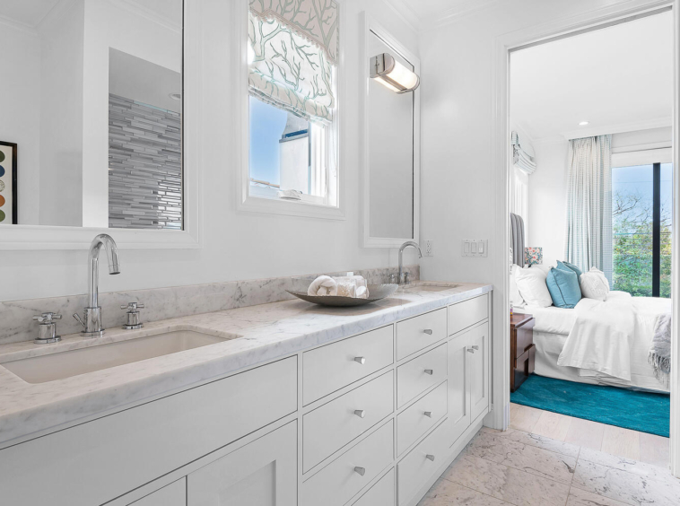 Mostly white bathroom with large two-sink vanity