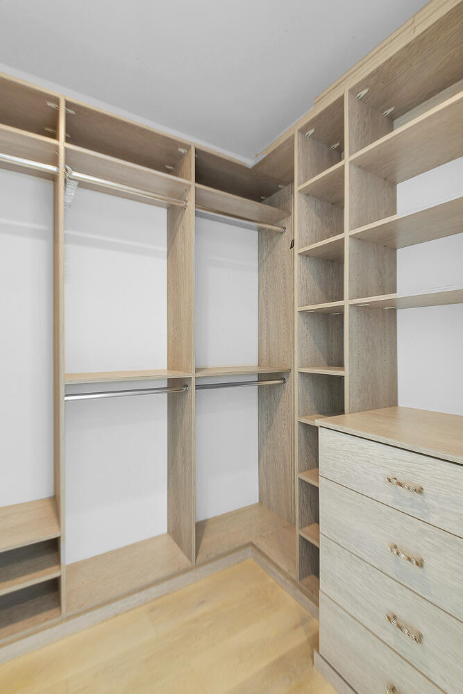 Walk-in closet with custom built-in organizers and drawers