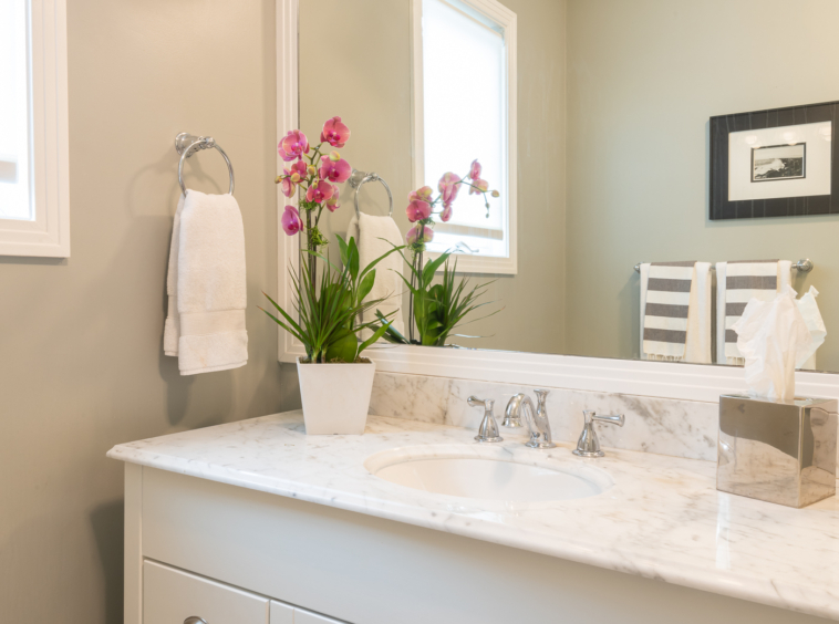 White bathroom one-sink vanity and large mirror