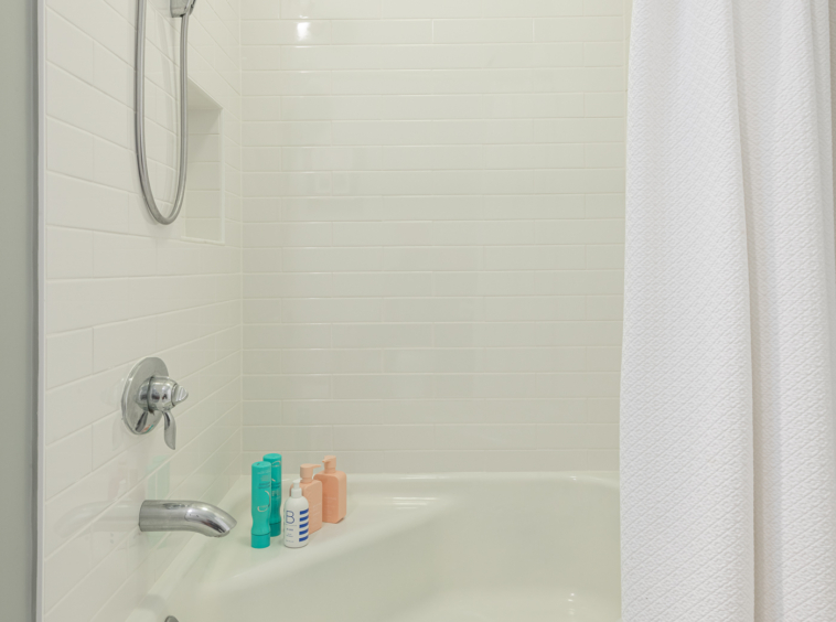 White tiled bathroom shower and tub
