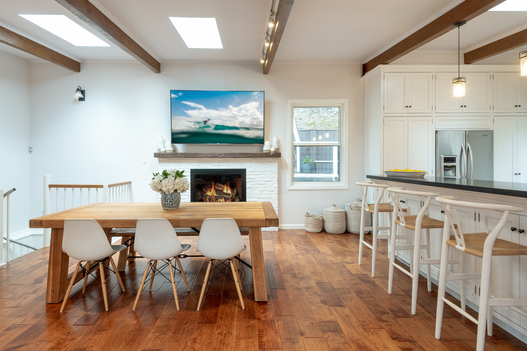 Bright dining room with wood exposed beams and hand hewn floor