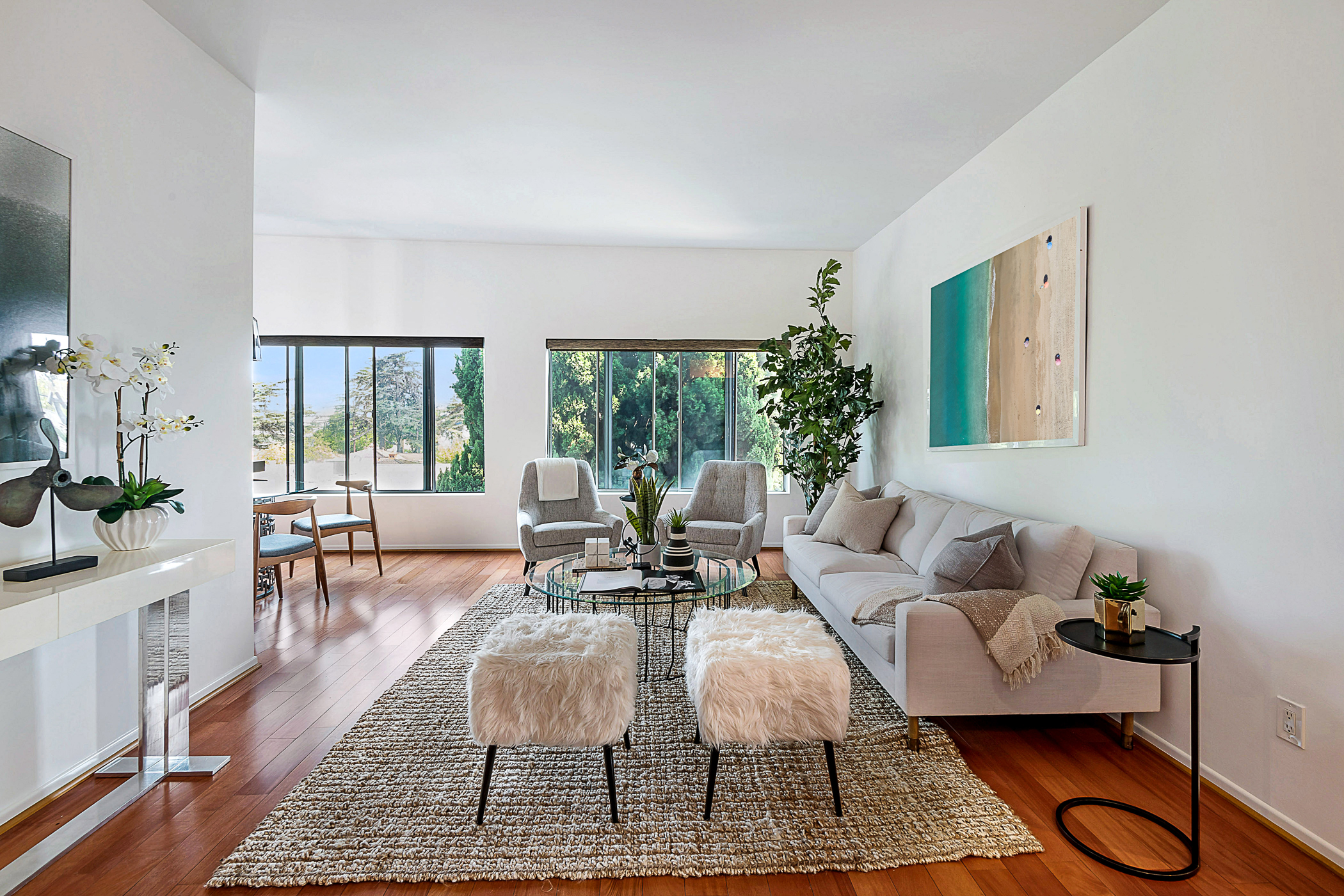 Modern living room with hardwood floors and large windows