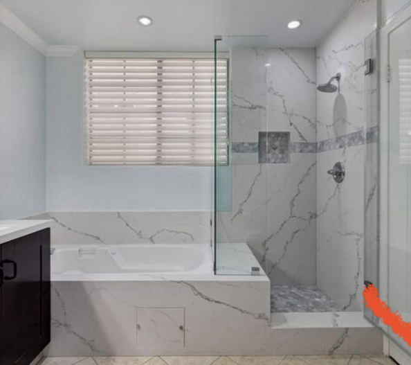 bathroom with tub and walk-in glass shower and marble