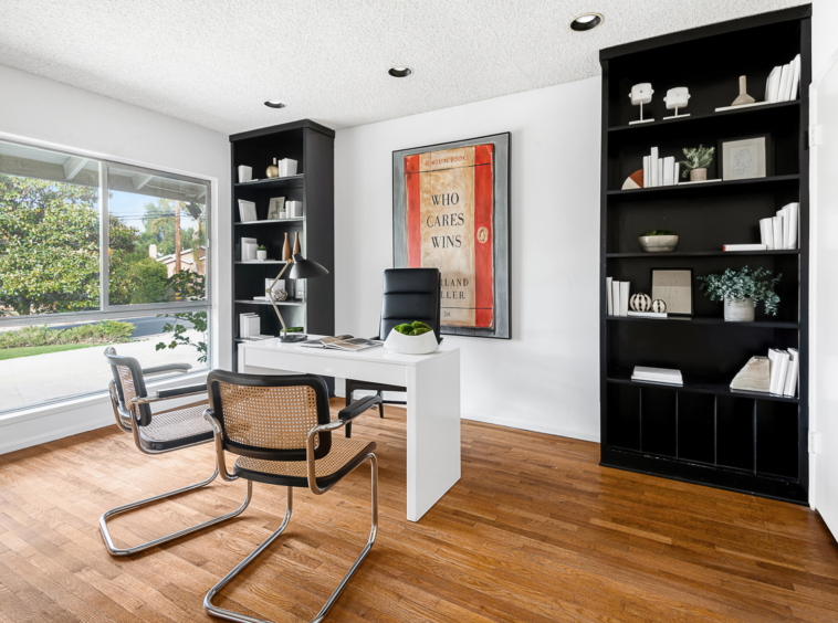 Office with Black book shelves and hardwood flooring