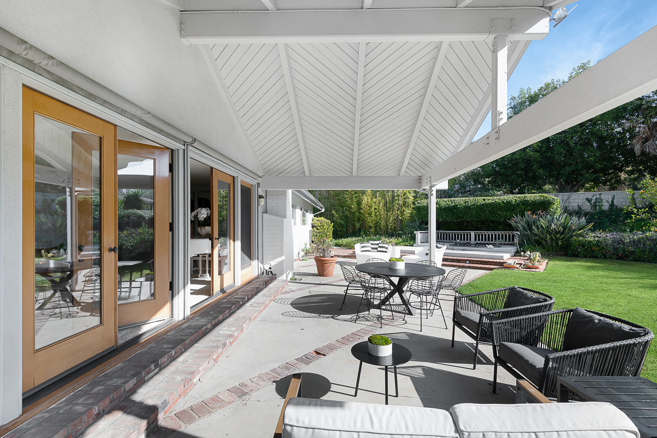 Chevron patterned white roof over patio space at the back of the house