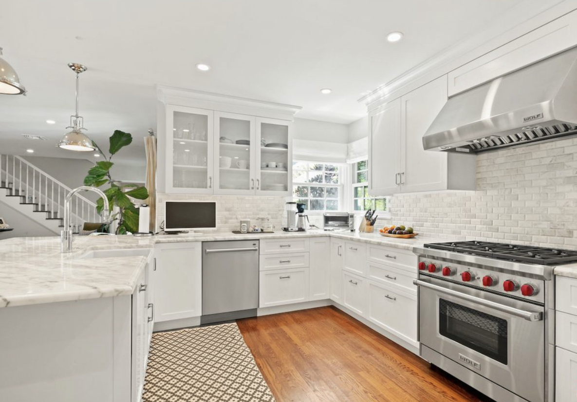 Modern white litchen with whote and grey granite and upscale stainless appliances