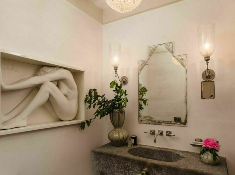 Bathroom with stone sink and sculpture of a woman