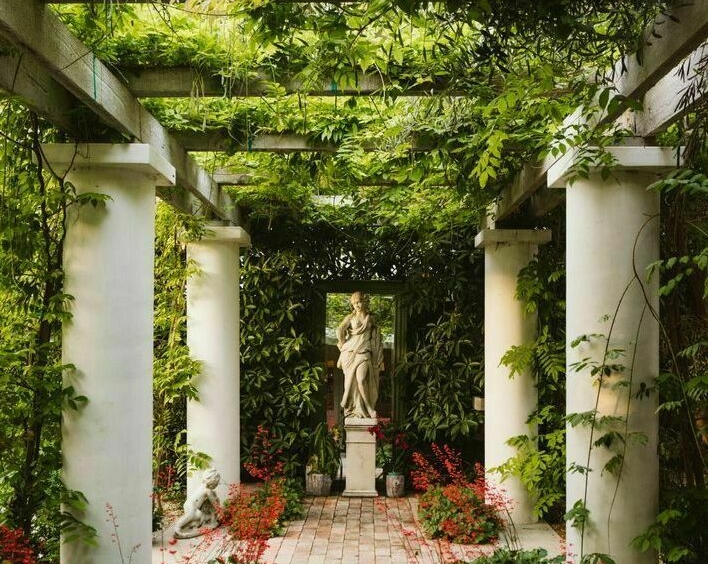 White column pergola and garden with classic sculpture