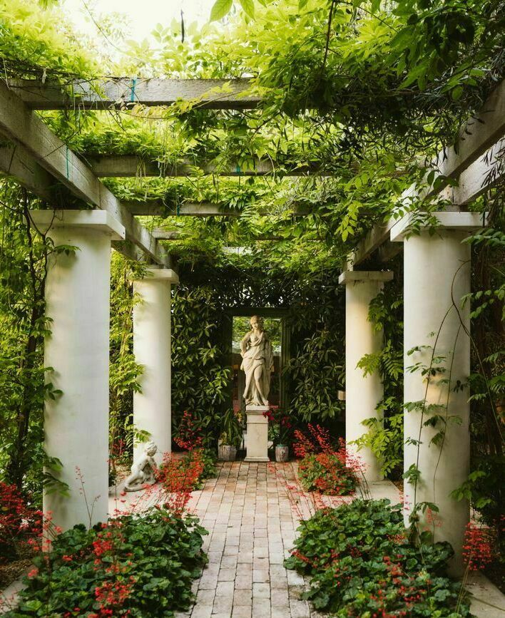 White column pergola and garden with classic sculpture