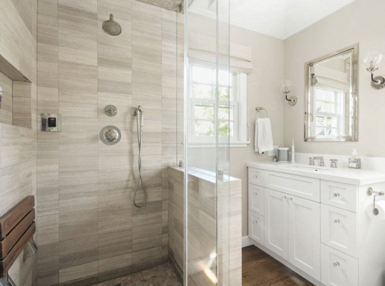 White and grey bathroom with walk-in shower and single vanity