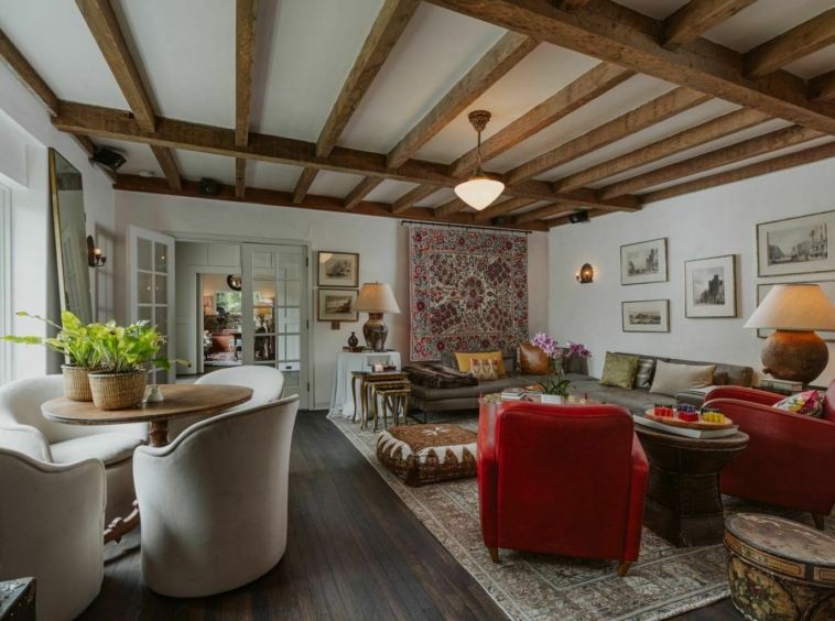 large living room with slanted ceiling and wood beams