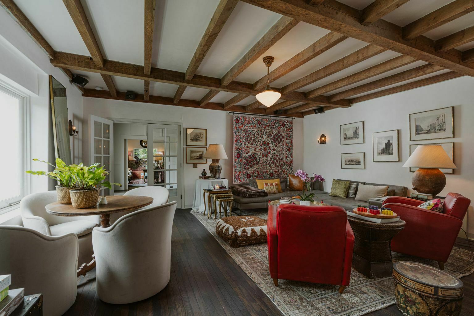 large living room with slanted ceiling and wood beams