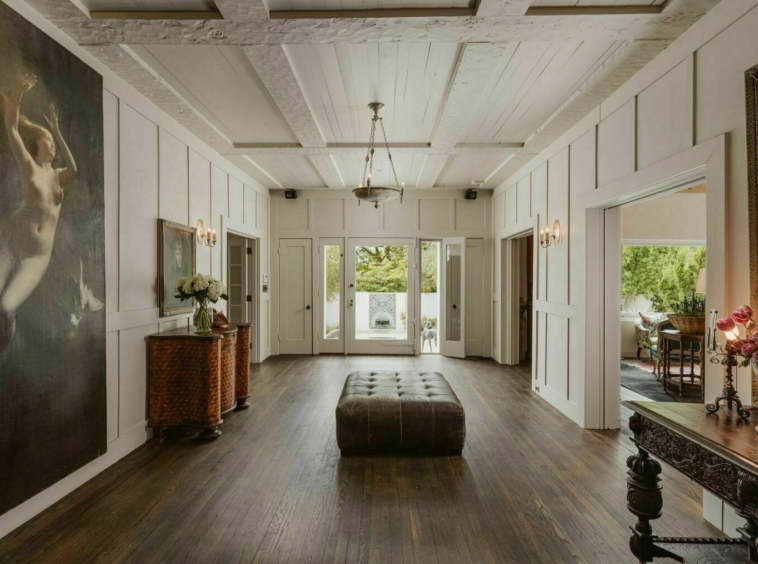 Large foyer with white hand hewn beams and dark hardwood floors