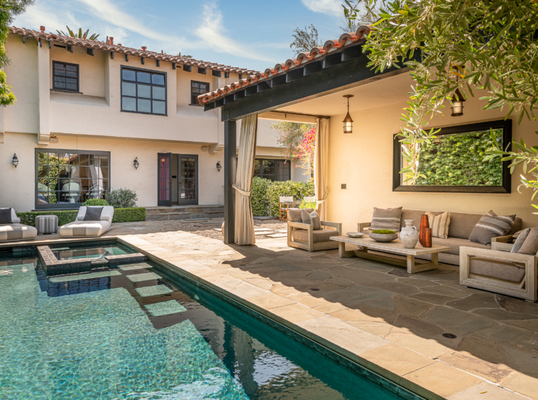 Spanish style home with pool and large stone patio area