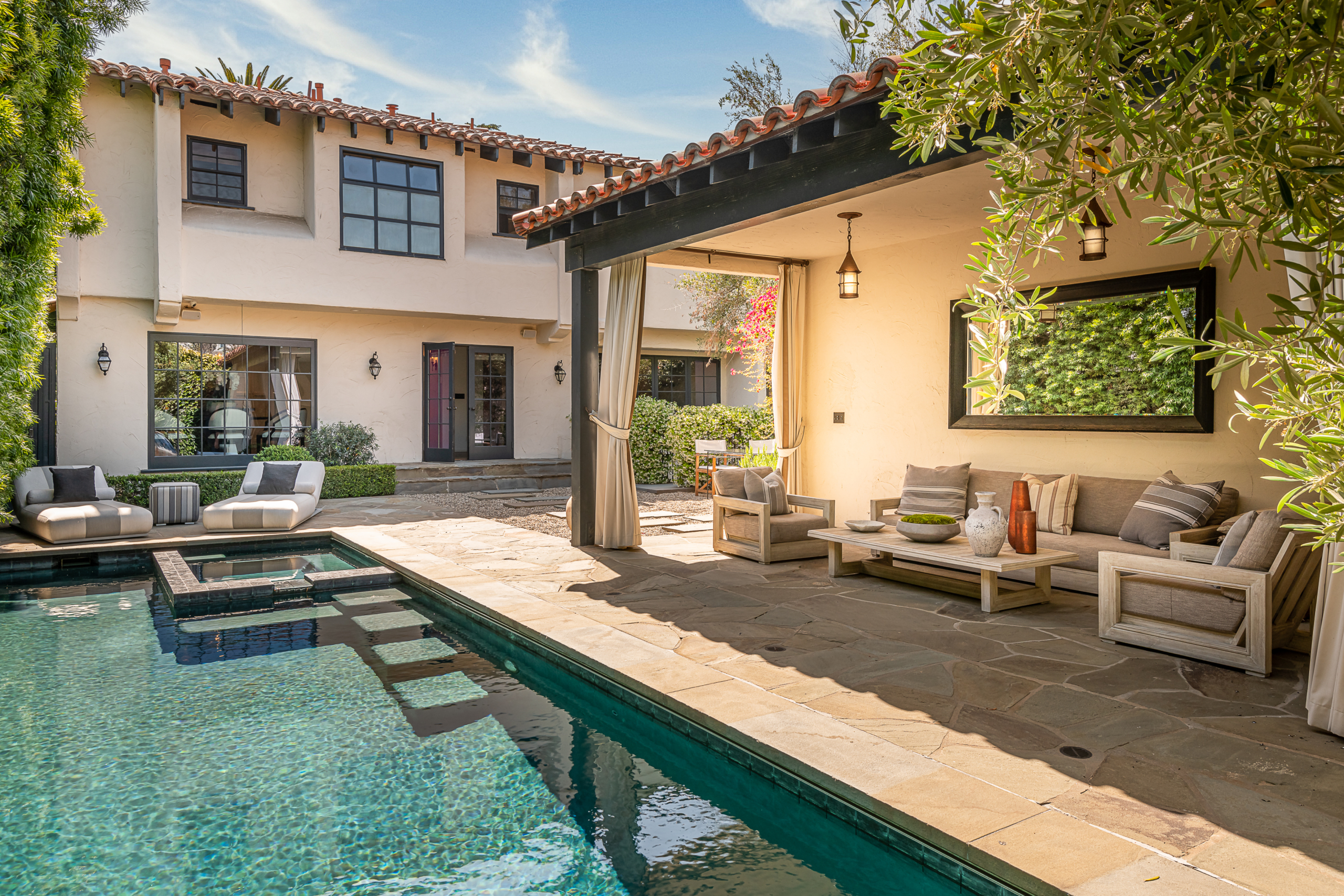 Spanish style home with pool and large stone patio area