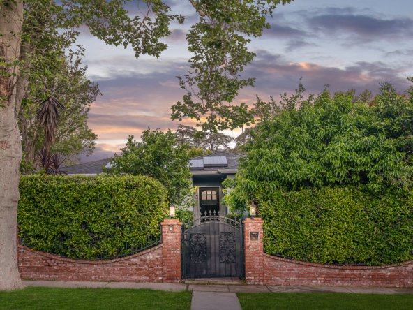 gated front entrance and privacy hedges