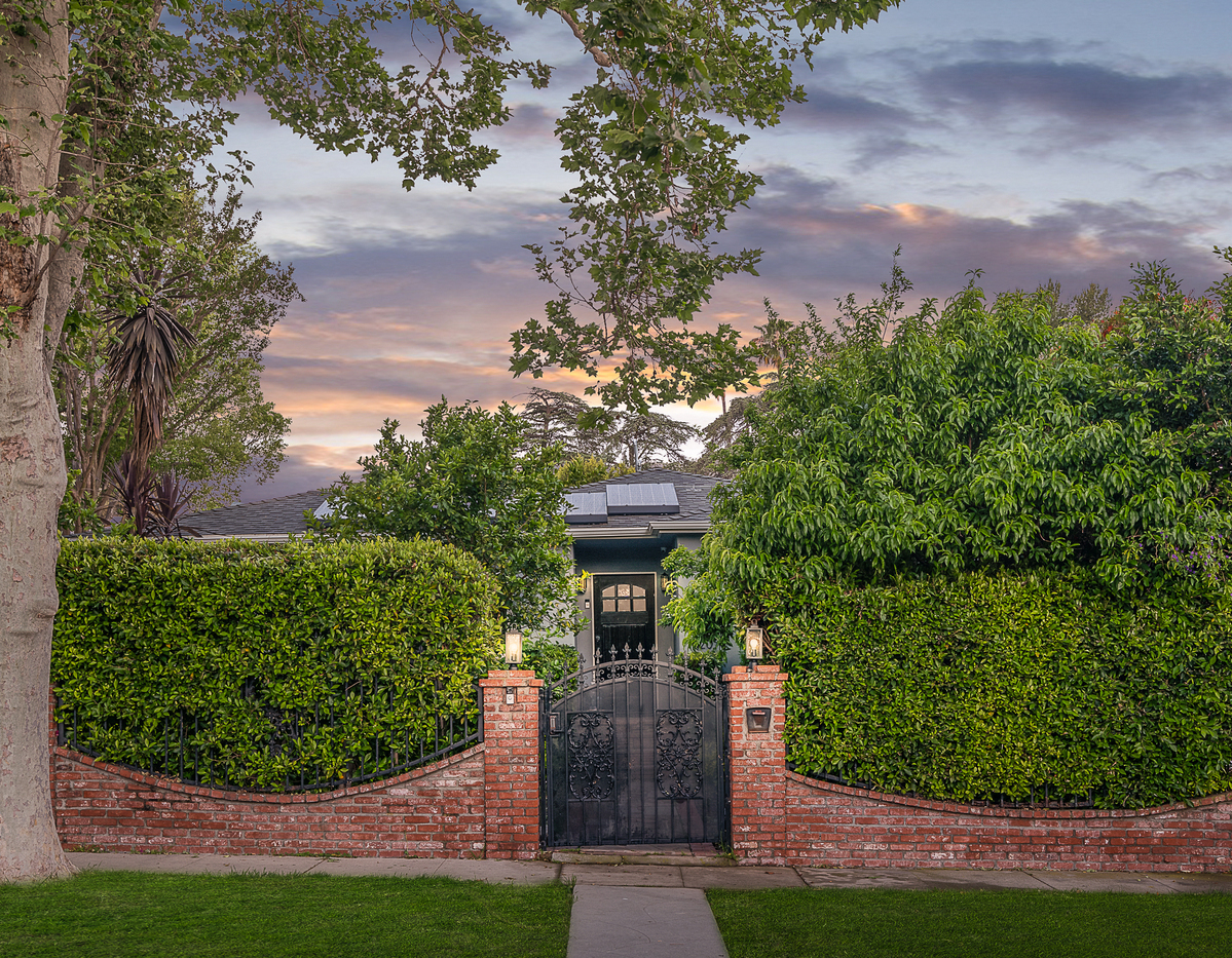 gated front entrance and privacy hedges