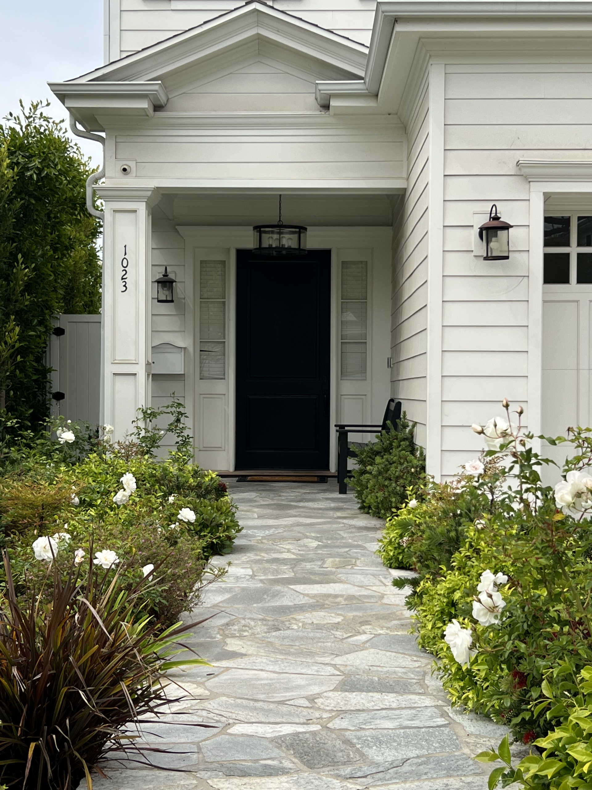 White home with field stone walkway front door