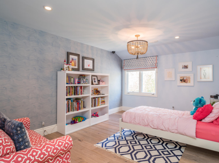 Child's bedroom with bed, chair and bookshelves