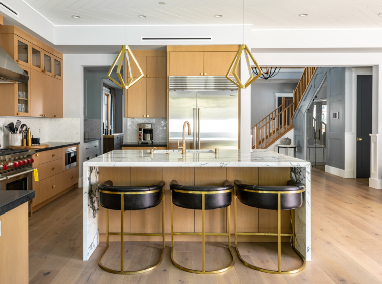 contemporary kitchen with marble wrapped breakfast bar, gold fixtures and upscale appliances