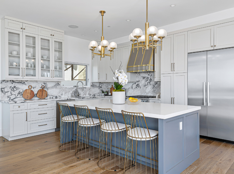 The gorgeous and spacious Chef's kitchen comes complete with marble countertops, custom cabinetry with plenty of storage space, high-grade stainless appliances, and a wine fridge, ideal for at-home entertainment.