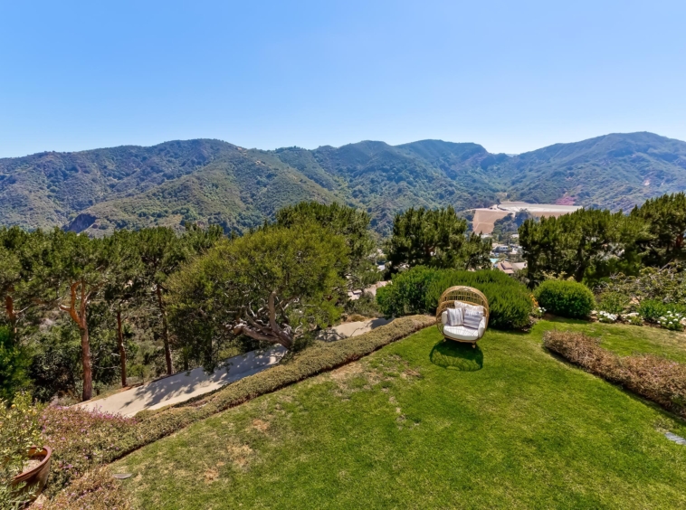 Areal view of spacious backyard overlooking the mountain range