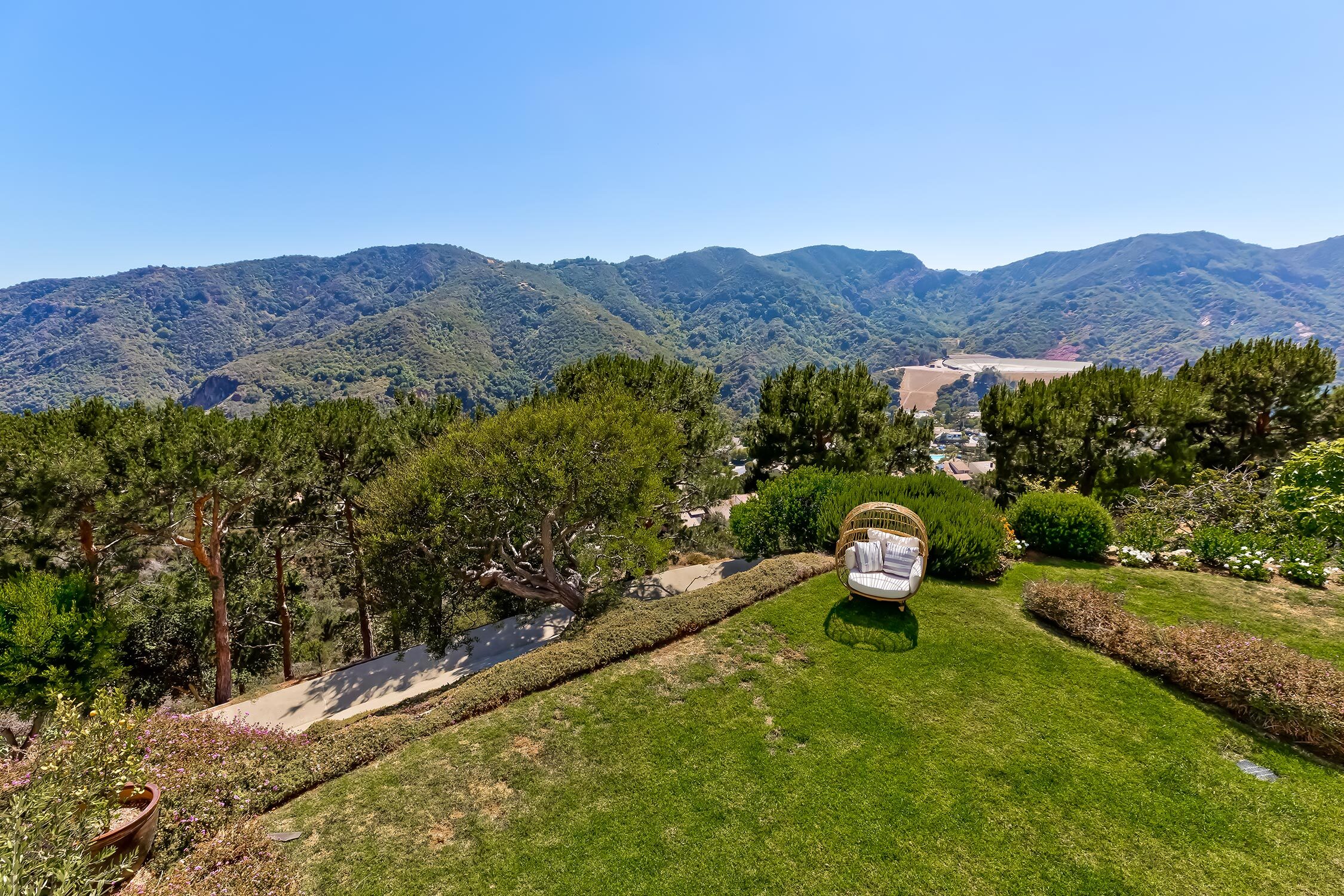 Areal view of spacious backyard overlooking the mountain range