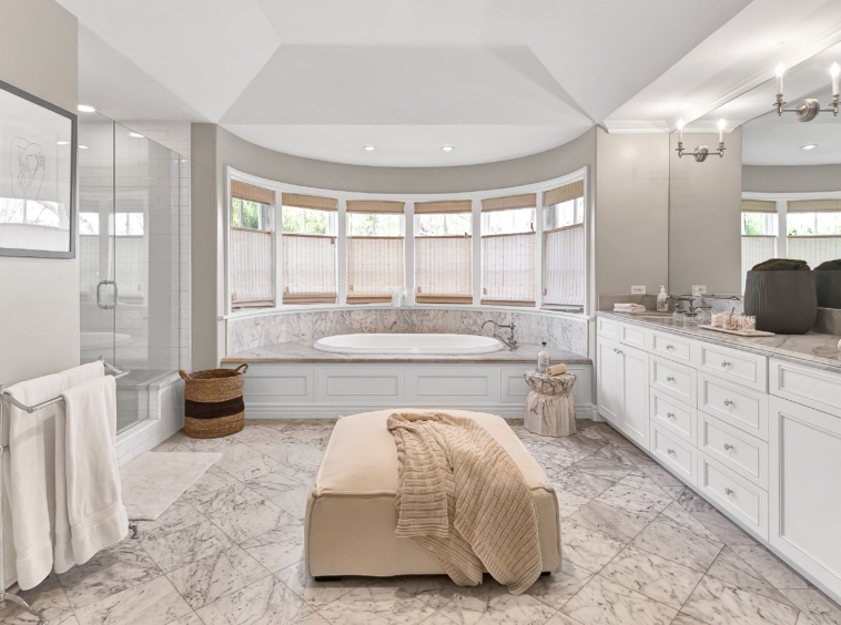 Highly sought-after Ken Ungar designed Quintessential Cape Cod in Brentwood CA. Bright white master bathroom with large soaker tub, separate glass, door shower and marble floors.