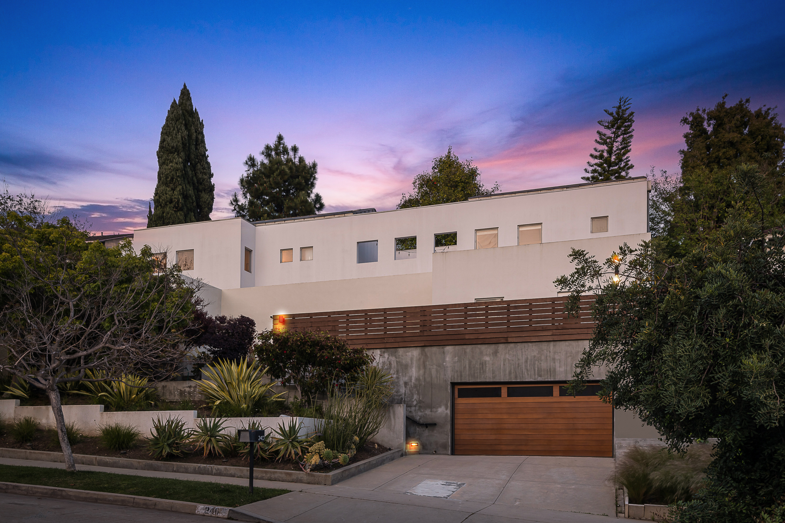 Beautiful modern estate with Mid-century modern facade and concrete planter landscaping