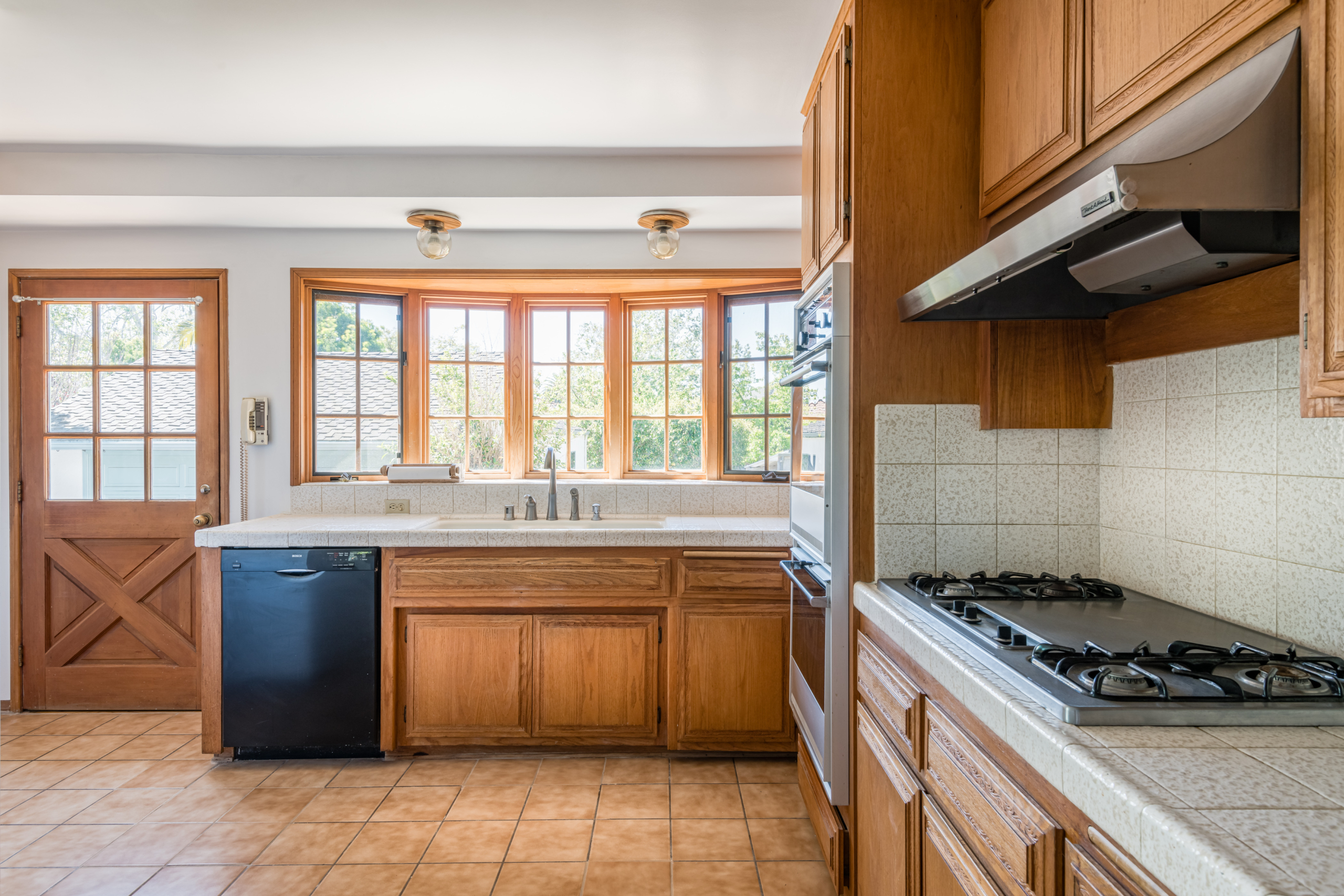 367 N GRENOLA Kitchen with Spanish ceramic tiles and oak cabinets