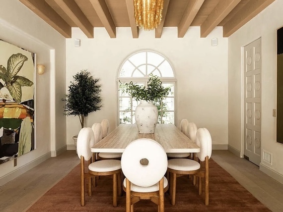 Luxury, neutral dining room with wood beamed ceiling in Los Angeles home