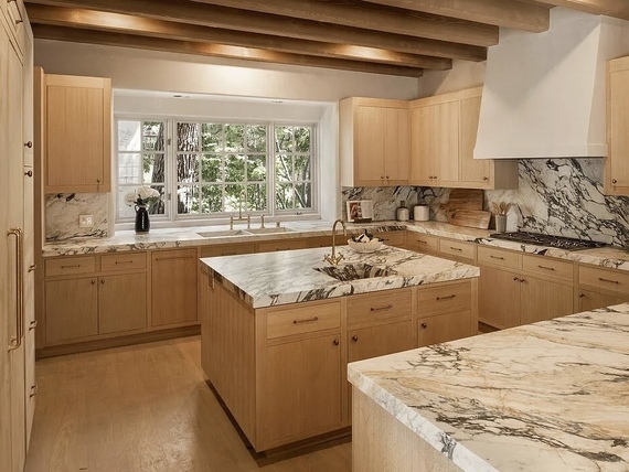 Luxury, neutral kitchen with wood beamed ceiling