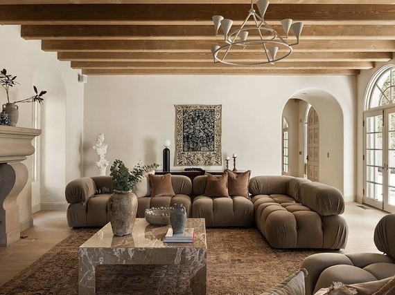 Luxury, neutral living room with wood beamed ceiling