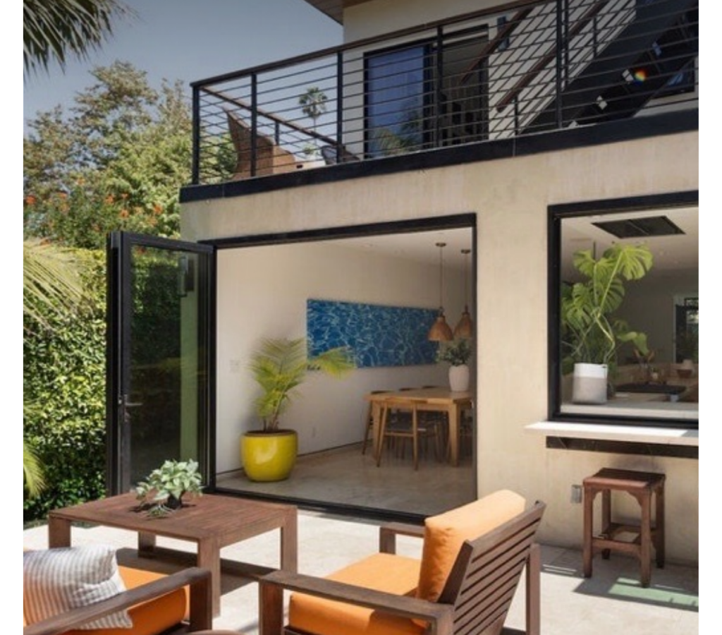 235 Entrada Dr | Santa Monica Canyon Back of home with floor to ceiling open doors to backyard.
