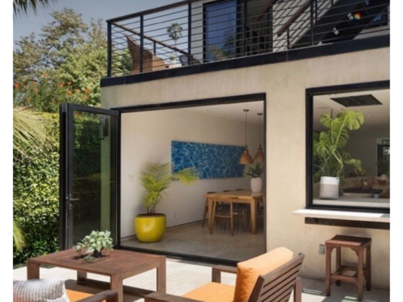 235 Entrada Dr | Santa Monica Canyon Back of home with floor to ceiling open doors to backyard.