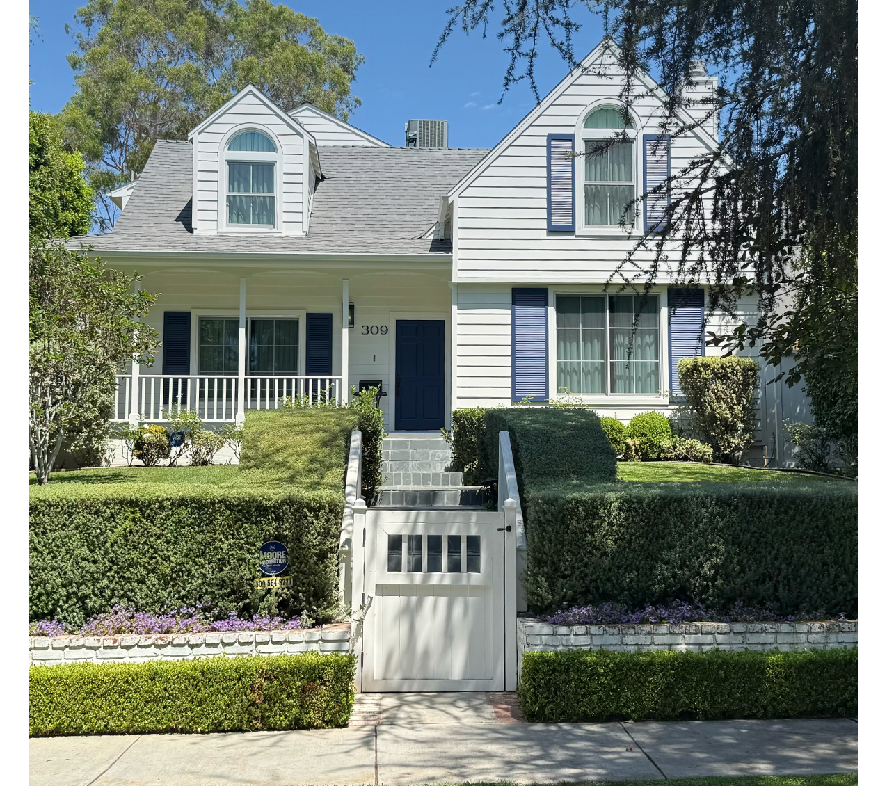 309 21st Place | Santa Monica 309 21st Place | Santa Monica View of he front of the white home with shutters, green lawn, large hedge and gated entrance to walkup steps and front porch.