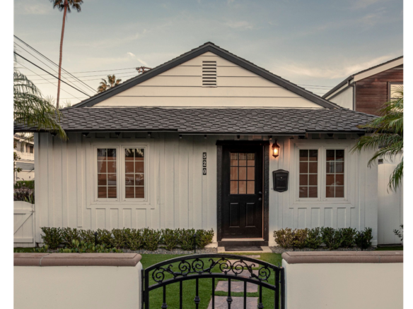 520 MARIGOLD AVE | CORONA DEL MAR front of white home behind white wall and iron gate.
