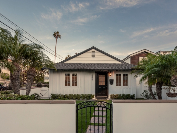 520 MARIGOLD AVE | CORONA DEL MAR view of front of the property. The home is white with a black roof/